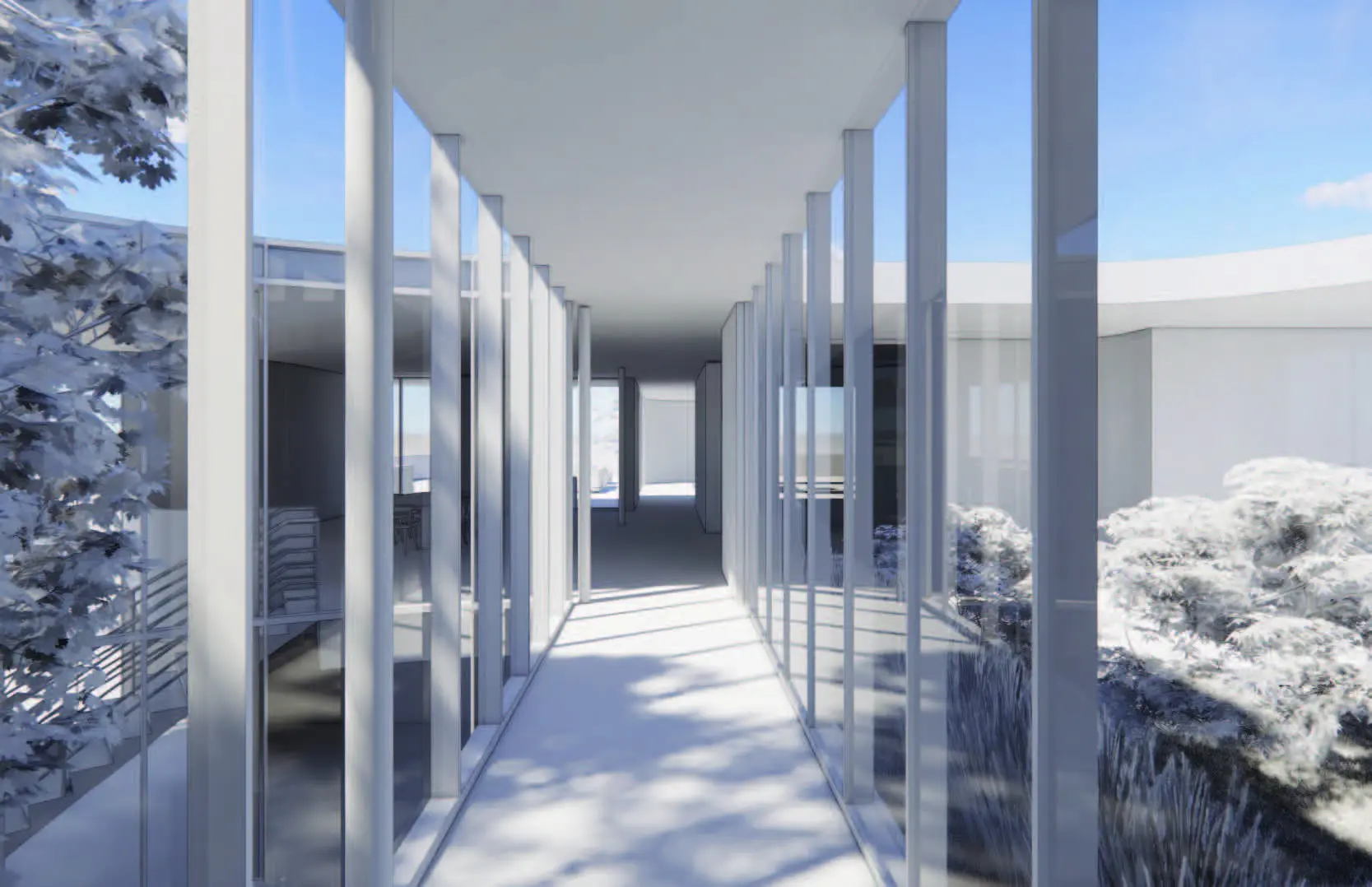 Glass corridor connecting spaces with natural light and views of landscaped courtyard.