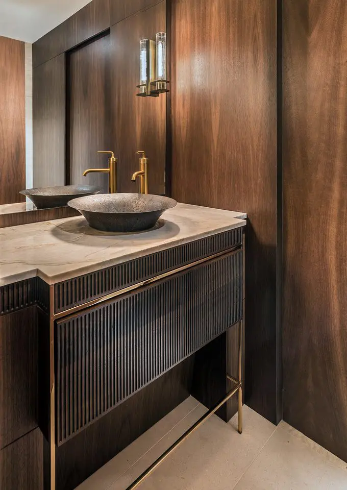 Contemporary bathroom with wood paneling and stone vessel sink.