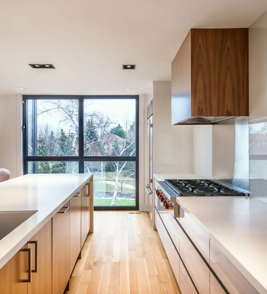 Contemporary kitchen with floor-to-ceiling windows and natural wood finishes.