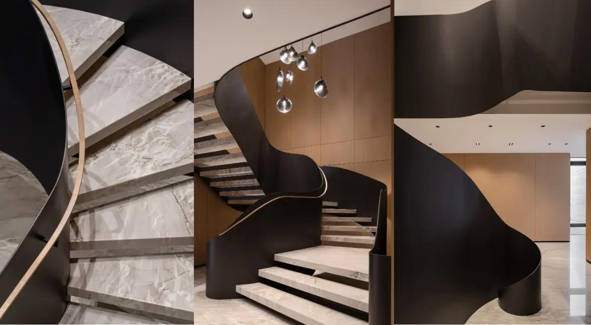 Modern staircase design with marble steps and curved architectural form.