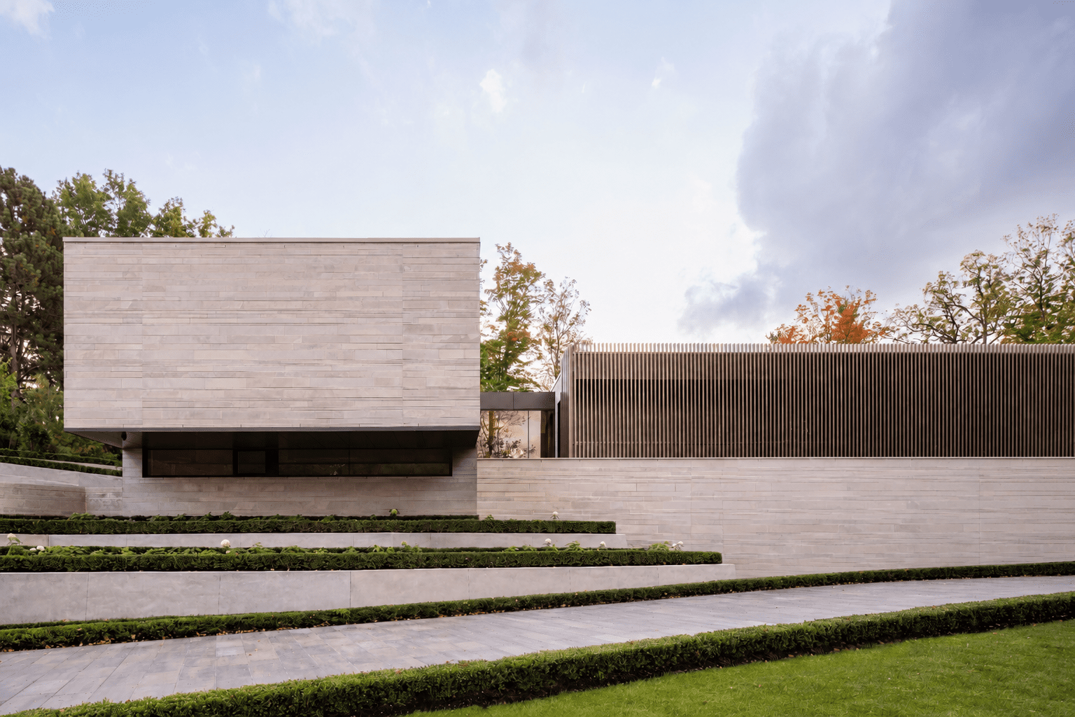 Modern luxury home with stone façade and minimalist architectural design.
