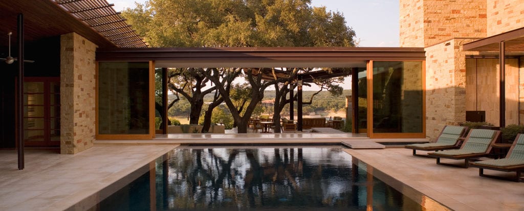 Courtyards in architecture are a great way to bring outside light in. Connecting living spaces with nature, here's why they should be in your home design. Courtyard at Lake Travis Retreat by Dick Clark and Associates.