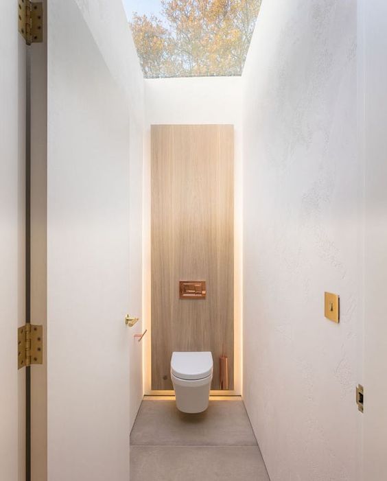 A well lit and modern outdoor indoor bathroom designed with sleek features.