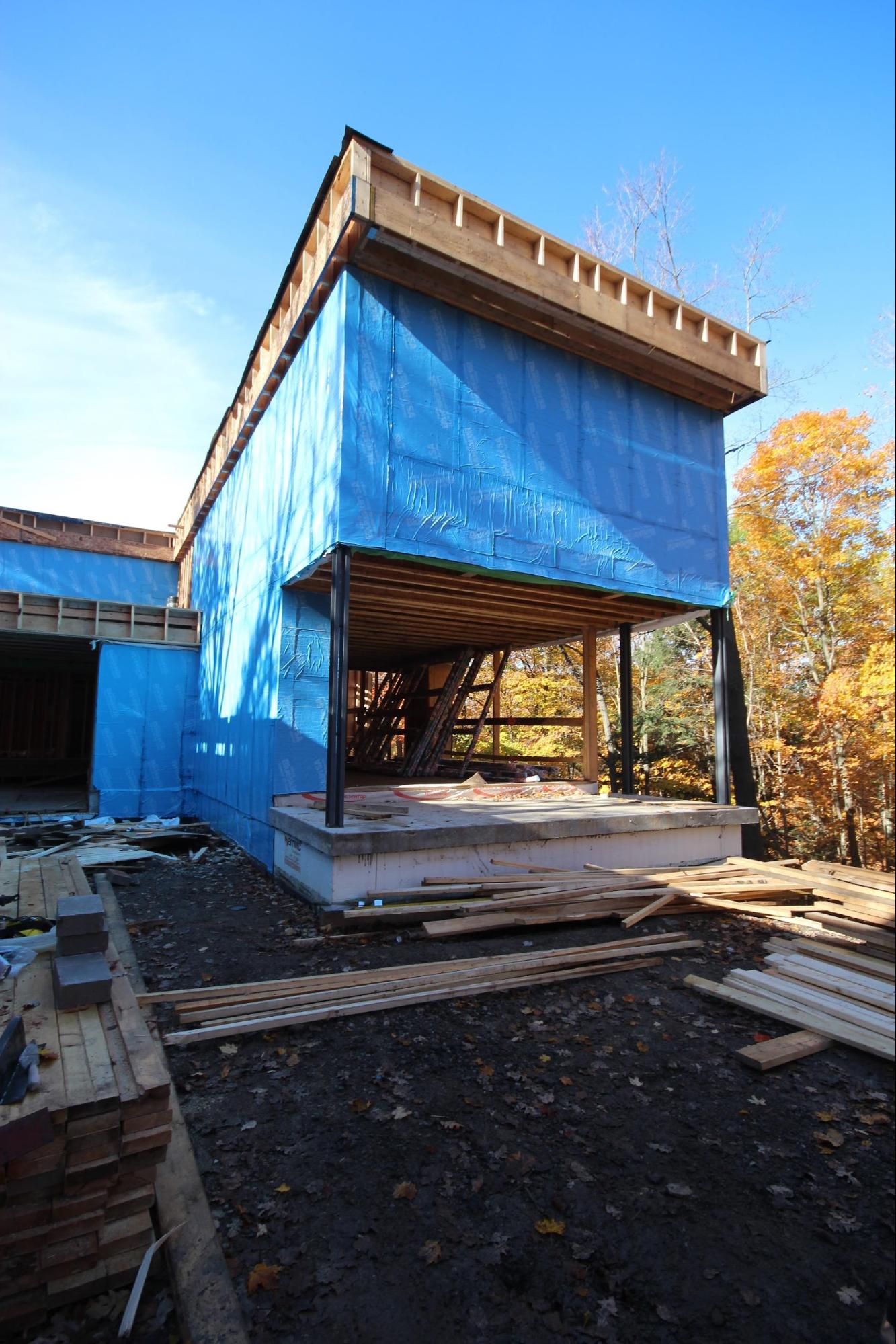 The exterior of a custom home under construction that is enclosed and sealed before winter by frankfranco architects.