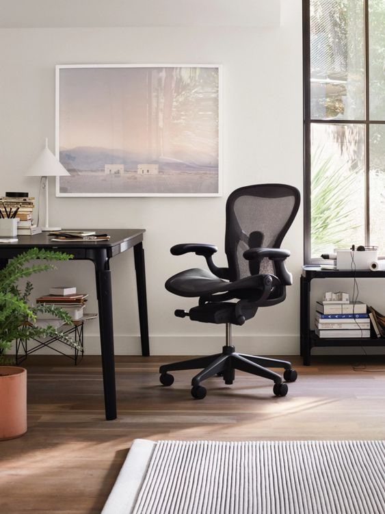 A Herman Miller Aeron chair in a custom home office with large floor to ceiling windows