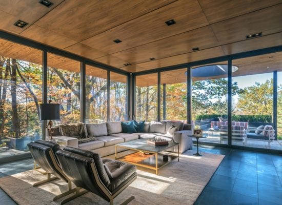 Gorgeously spacious interior design of renovated living room with floor to ceiling windows designed by FrankFranco Architects.