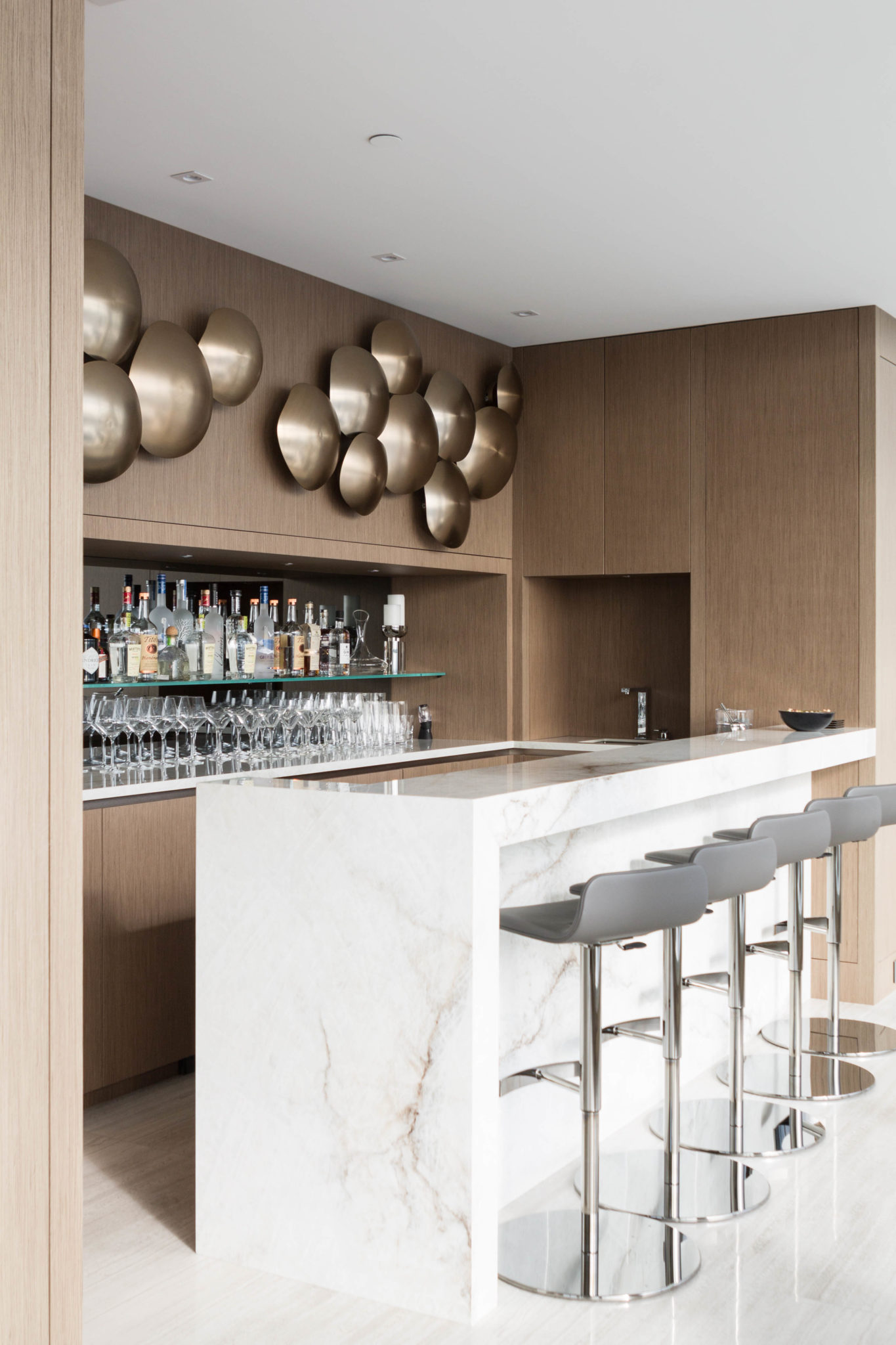 Gorgeous stacked wine display featured in a bar area of a home. Here's more features you should incorporate into a wine cellar design.