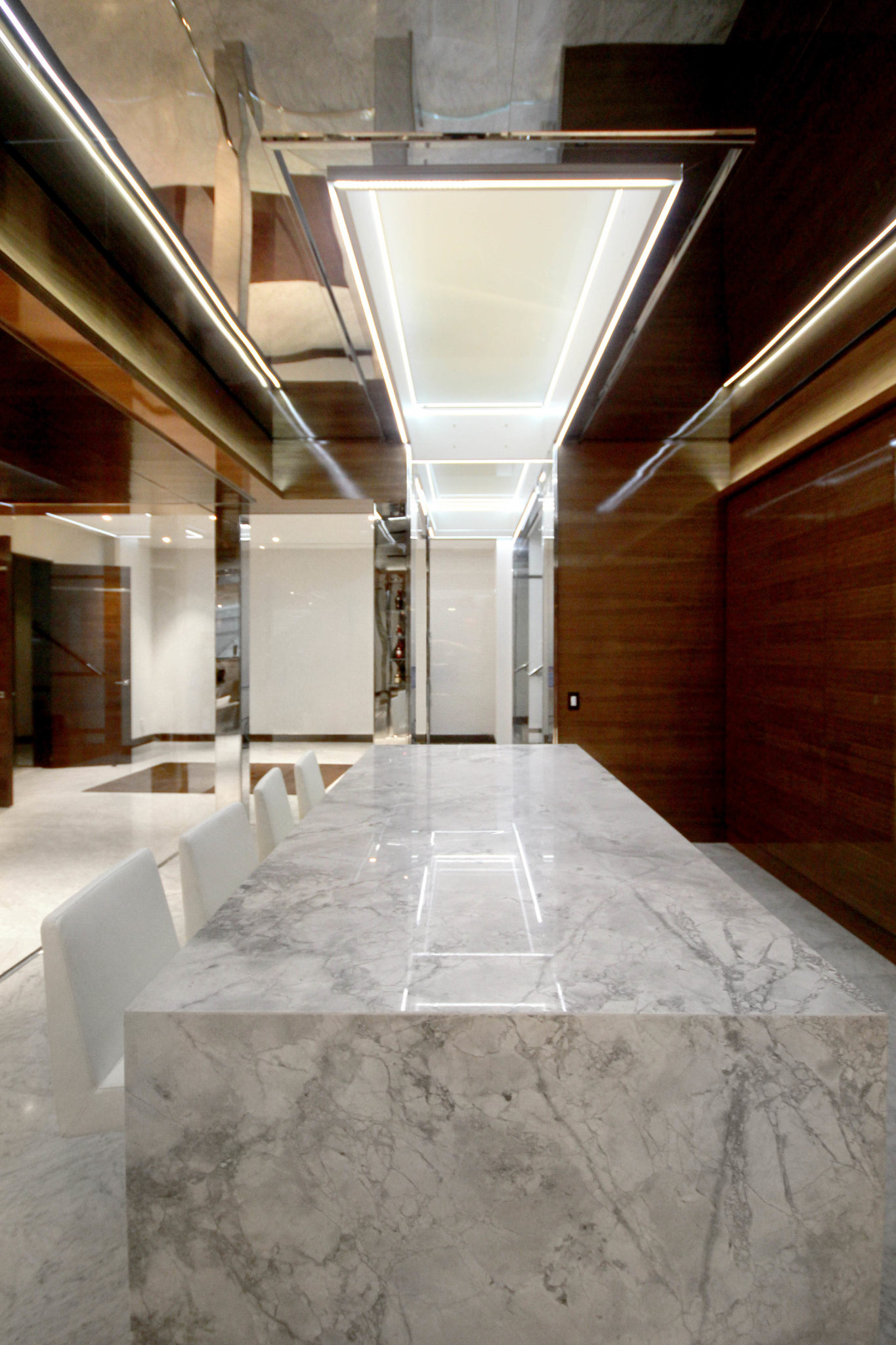 Beautiful white marble countertop featured in a wine cellar design. Here are more features you want to consider when designing your custom wine cellar.