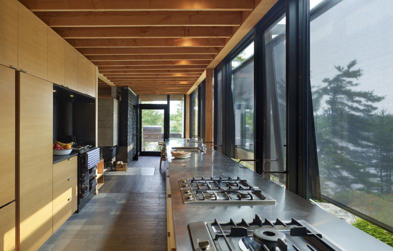 Hallway featuring floor to ceiling windows of a modern cabin in Go Home Bay