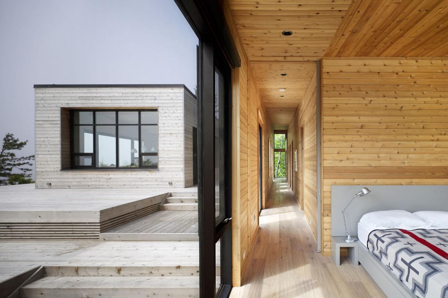 Vast indoor outdoor of a waterfront cottage designed by Superkul